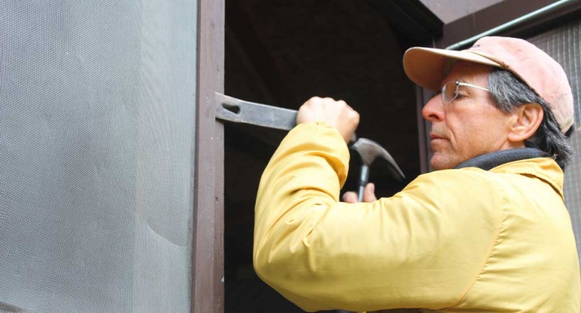 A person uses tools during a service project with Outward Bound.